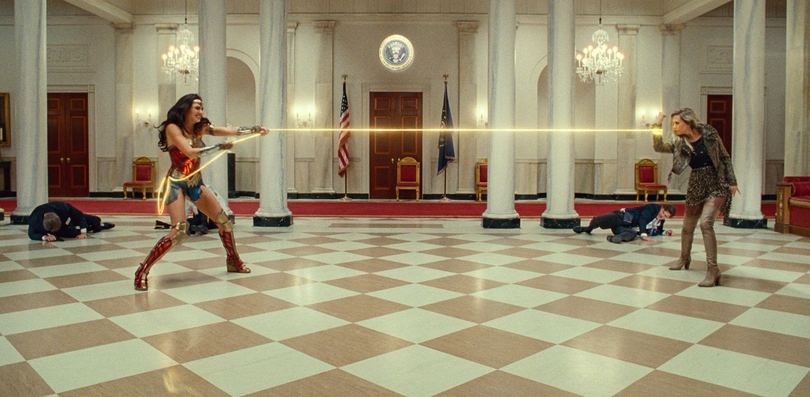Wonder Woman doing a tug of war with her lasso and another woman